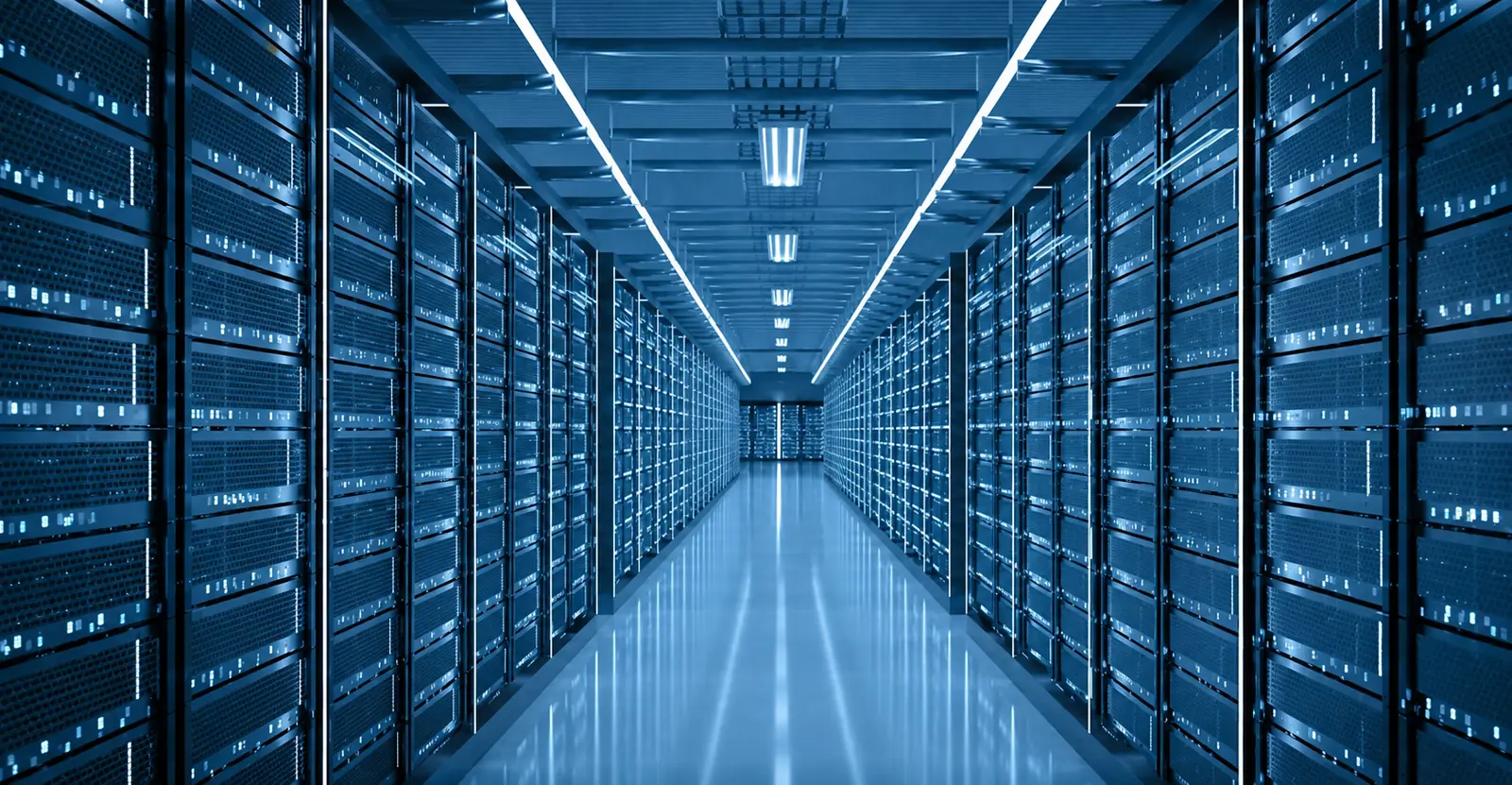 Long data centre aisle lined with illuminated server racks