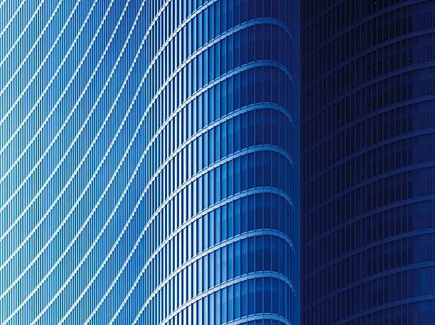 Curved blue glass facade of a corporate finance tower