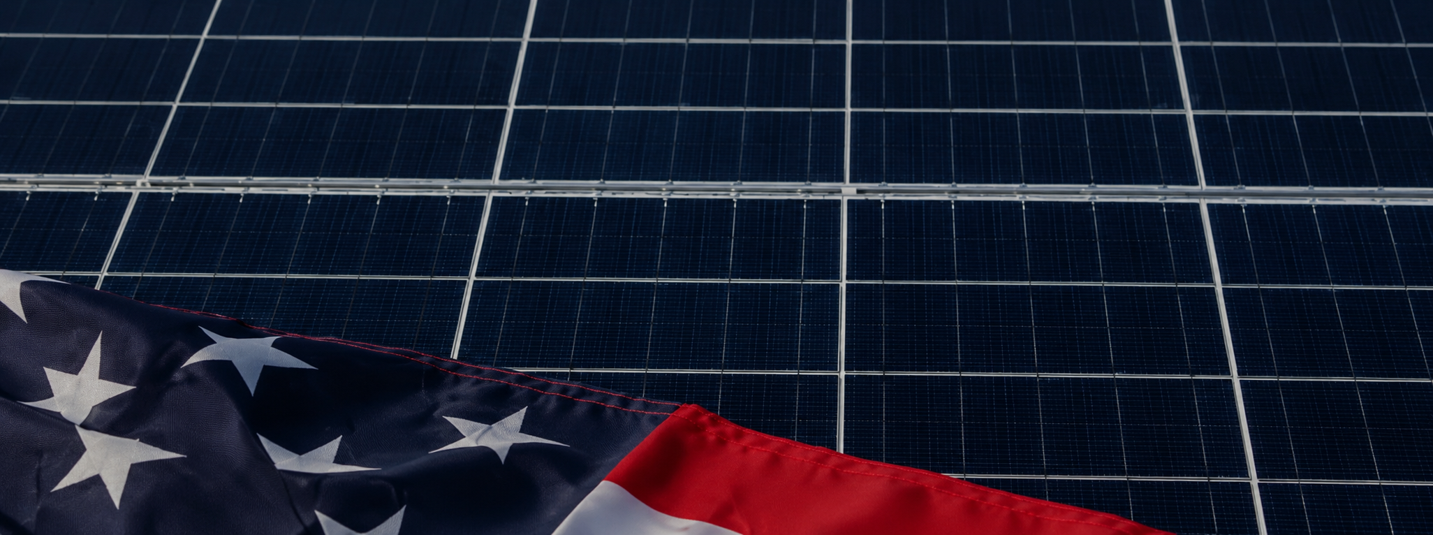 US flag resting across solar photovoltaic panels